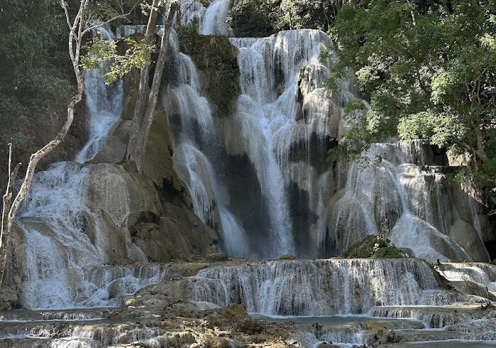 The multi-tiered Kuang Si Waterfall with crystal clear turquoise pools in Luang Prabang, a highlight on our Laos cycling tour.