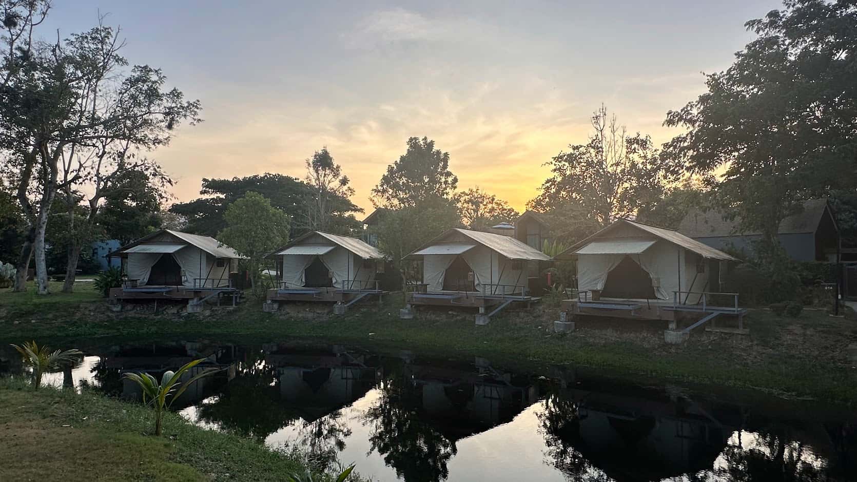 Luxury tented villas at a serene riverside resort in Kaeng Krachan, part of our hand-picked cycling tour accommodations.
