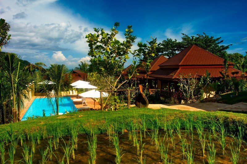 The swimming pool and beautiful wooden villas at Baan Taranya Resort on Koh Yao Yai Island, a featured stop on our Southern Thailand cycling holidays.