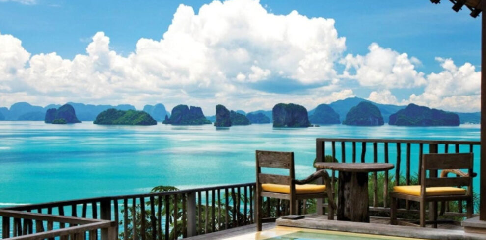 Panoramic view of limestone karst islands in Phang Nga Bay from a resort deck, a highlight of our Southern Thailand cycling holidays.