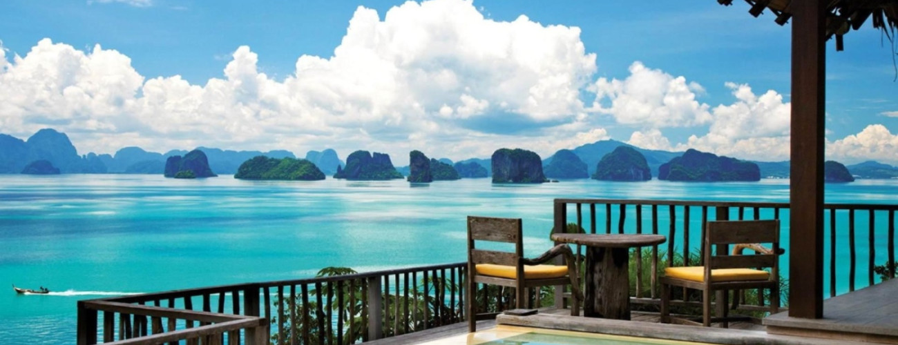 Panoramic view of limestone karst islands in Phang Nga Bay from a resort deck, a highlight of our Southern Thailand cycling holidays.
