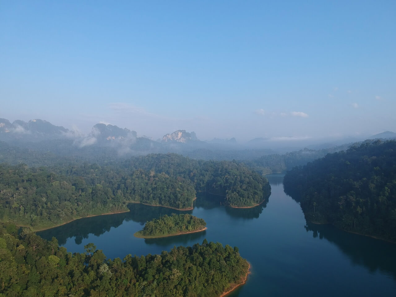 Stunning view of karst mountains and emerald water at Khao Sok National Park on a Thailand Cycle Tours route.