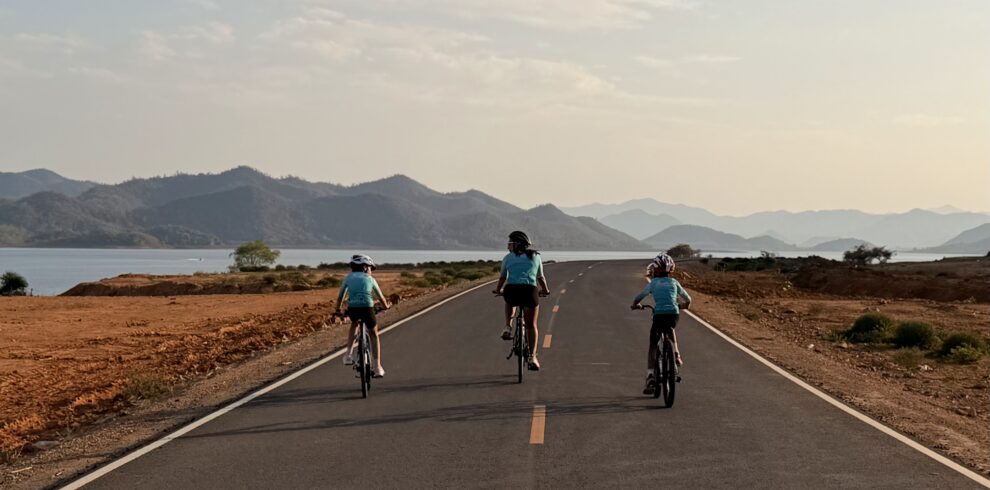 Family cycling adventure holidays in Thailand with Thailand Cycle Tours, featuring parents and children riding together through tropical landscapes, quiet coastal roads, national parks, and beautiful beaches on fun and memorable family-friendly bike tours.