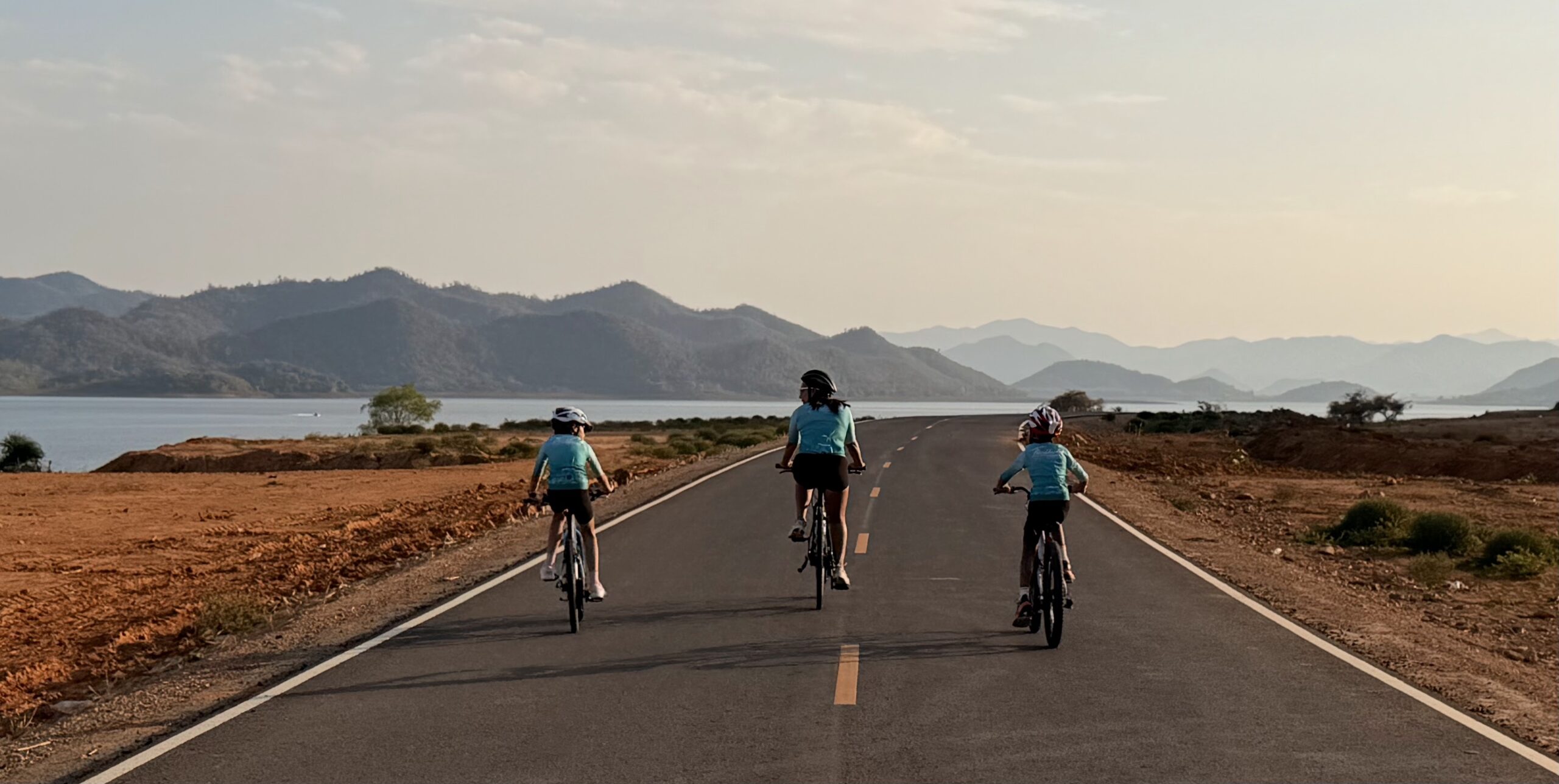 Family cycling adventure holidays in Thailand with Thailand Cycle Tours, featuring parents and children riding together through tropical landscapes, quiet coastal roads, national parks, and beautiful beaches on fun and memorable family-friendly bike tours.