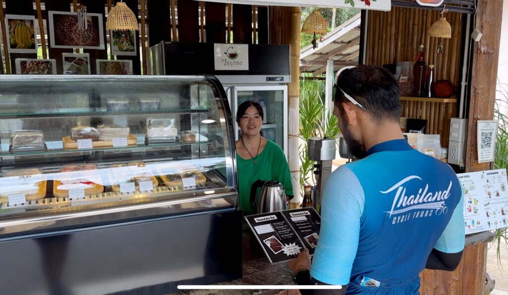 Thailand Cycle Tours cyclist enjoying a local cafΓ© stop during a cycling tour in Thailand